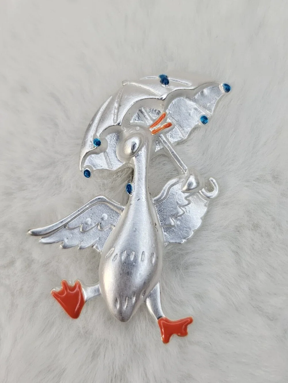 Playful Silver Goose Brooch with Orange Details